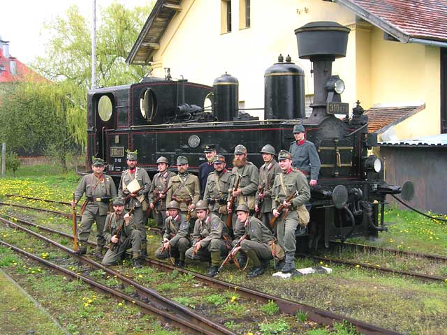 Steam engine set 97 (today 310.072) in the station Bezdružice with the historical group "Regiment No. 35" from First World War.