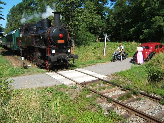 Steam train and a historical car near the station Konstantinovy Lázně.